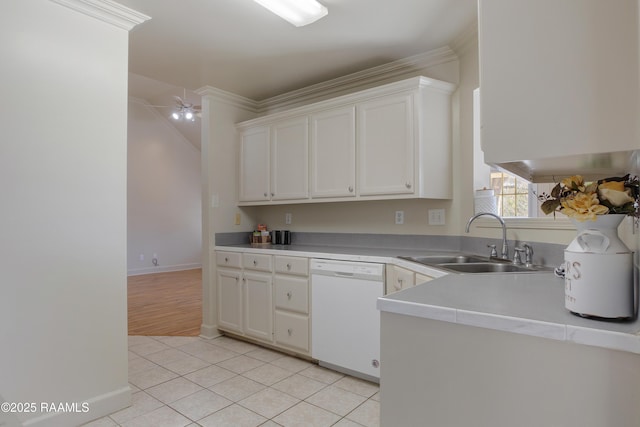 kitchen featuring sink, light tile patterned floors, crown molding, white dishwasher, and white cabinets