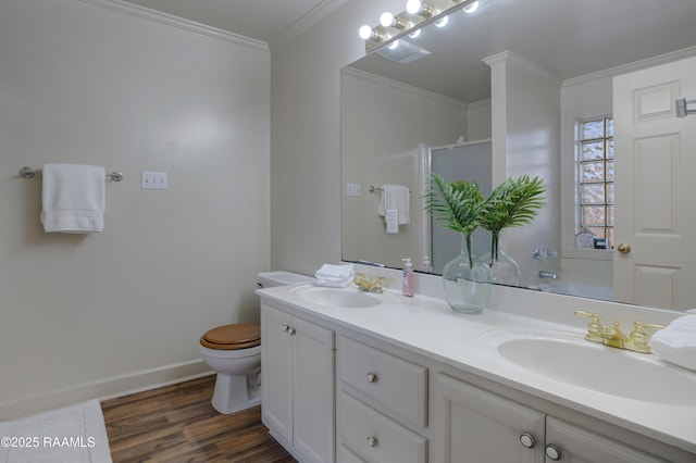 full bathroom featuring toilet, wood-type flooring, ornamental molding, vanity, and independent shower and bath