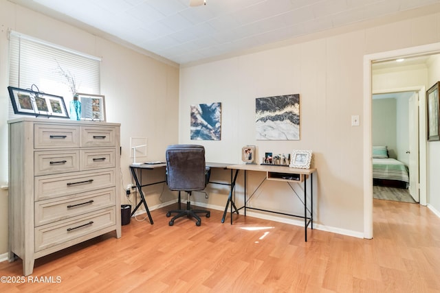 office with light wood-style floors and baseboards