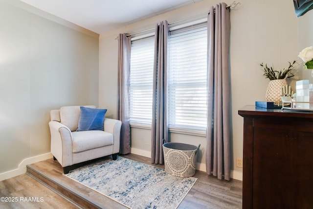 living area featuring light wood-style flooring and baseboards