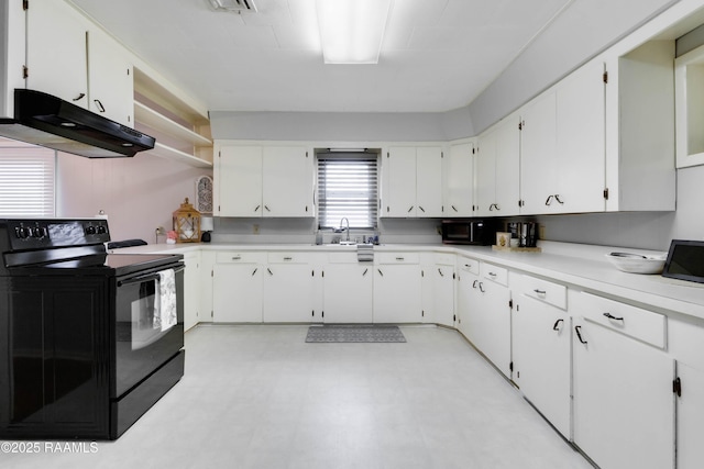 kitchen with black appliances, white cabinetry, and light countertops