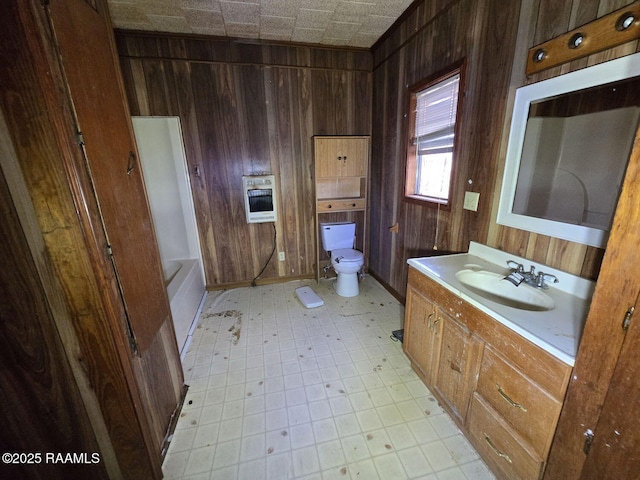 bathroom featuring toilet, heating unit, and wood walls