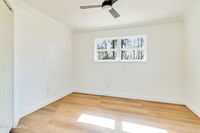 empty room featuring crown molding, ceiling fan, and light wood-type flooring