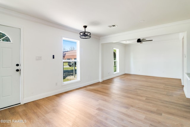 foyer with ornamental molding, ceiling fan with notable chandelier, and light hardwood / wood-style flooring