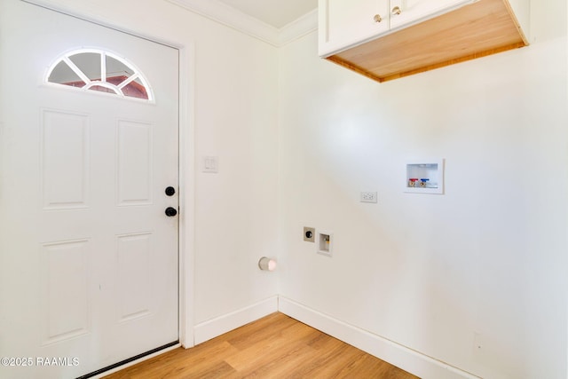 laundry area featuring cabinets, ornamental molding, hookup for a washing machine, hookup for an electric dryer, and light wood-type flooring