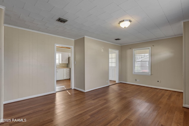 316 Kim Dr, Lafayette, LA 70503 - spare room with baseboards, wood finished floors, visible vents, and crown molding