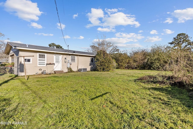 316 Kim Dr, Lafayette, LA 70503 - rear view of house with entry steps, a lawn, cooling unit, and fence