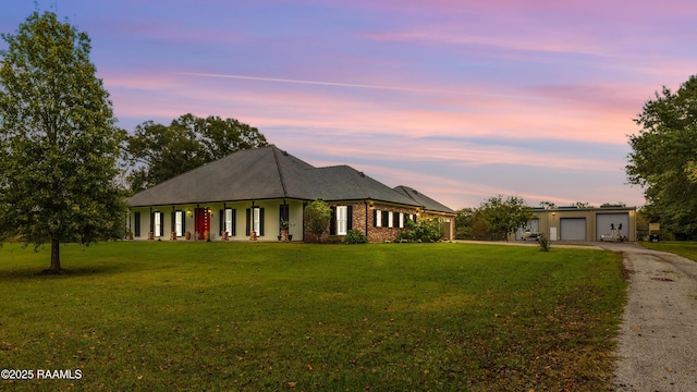 view of front of house featuring a garage and a lawn