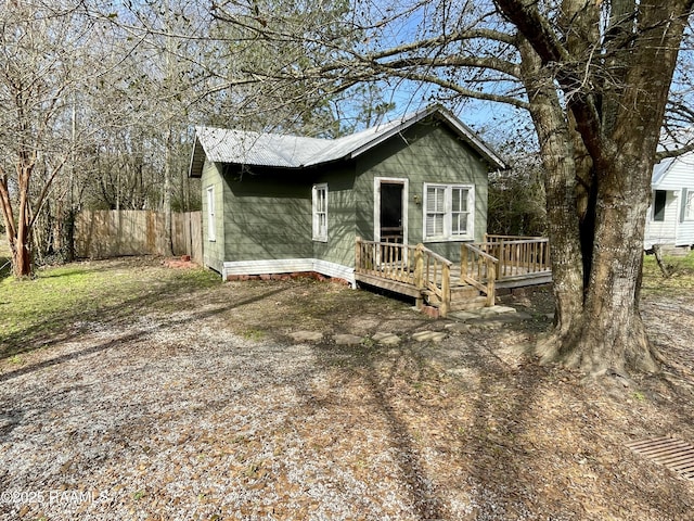 view of front facade with a deck and fence