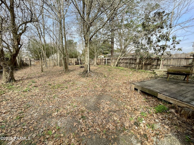 view of yard with a deck and a fenced backyard