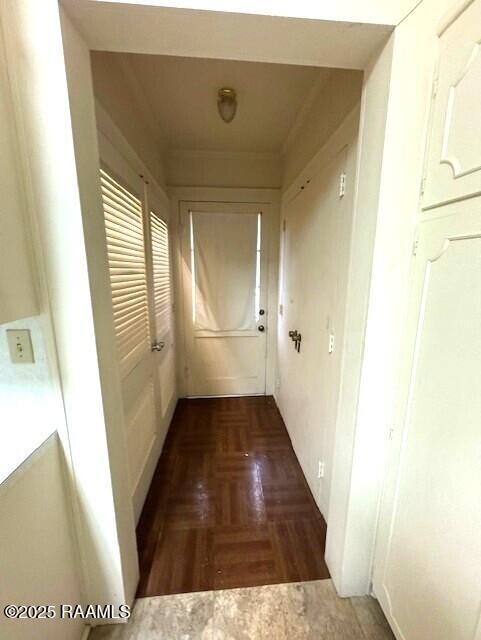 corridor with dark hardwood / wood-style flooring