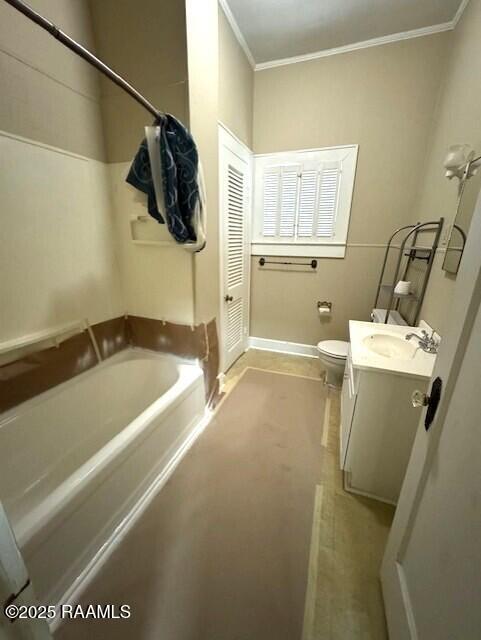 full bathroom featuring vanity, bathtub / shower combination, crown molding, and toilet