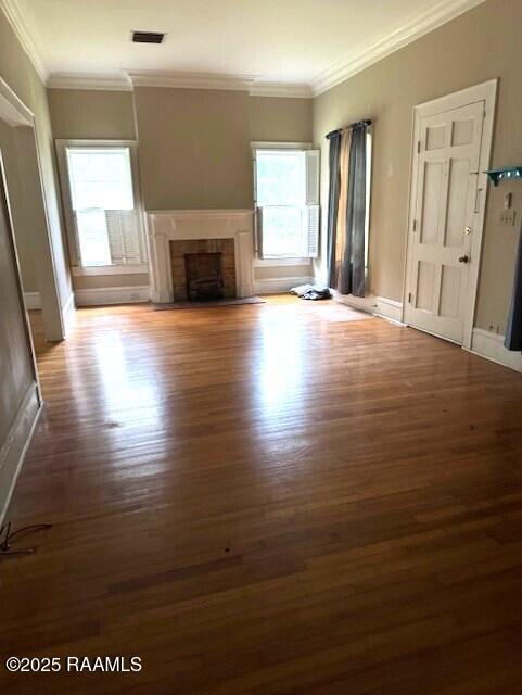 unfurnished living room with dark hardwood / wood-style flooring and ornamental molding