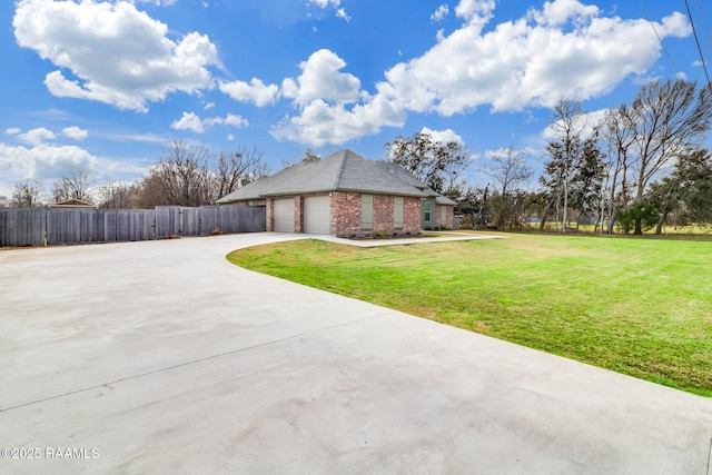 view of side of property with a garage and a yard