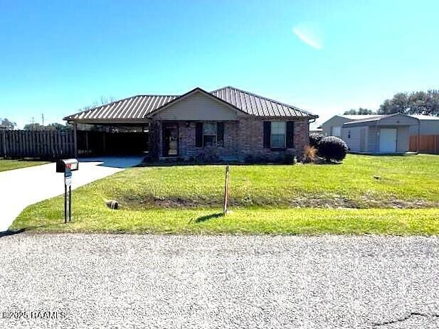 single story home with driveway and a front lawn