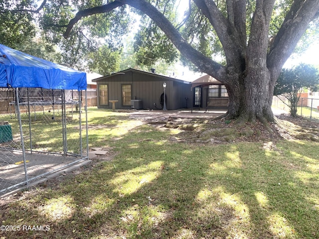 view of yard with cooling unit, a gazebo, and a trampoline