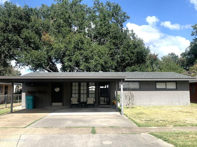 view of front of property with a front lawn and a carport