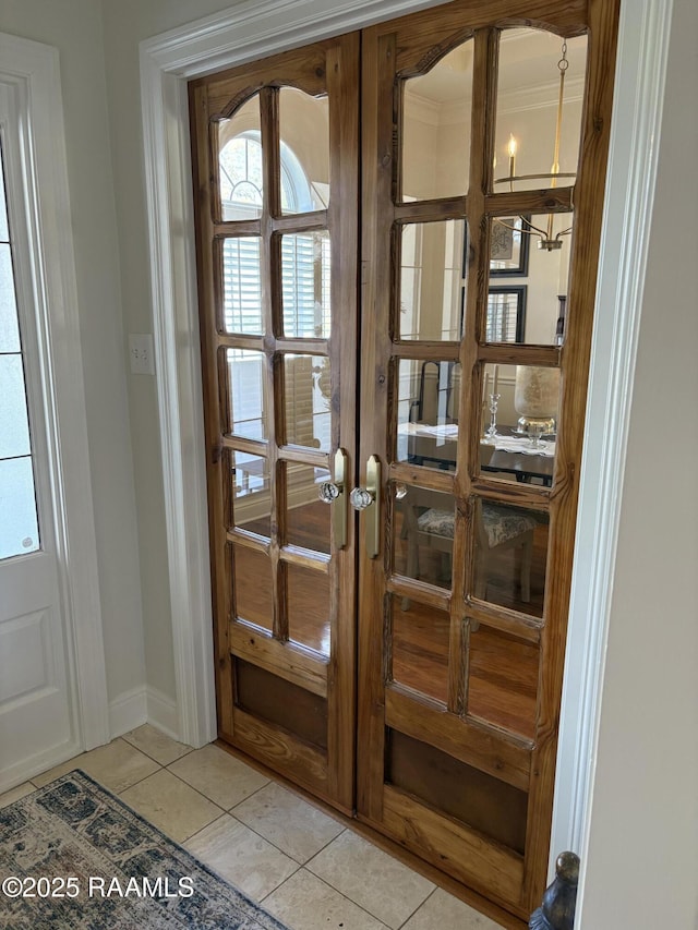 doorway with light tile patterned flooring and french doors