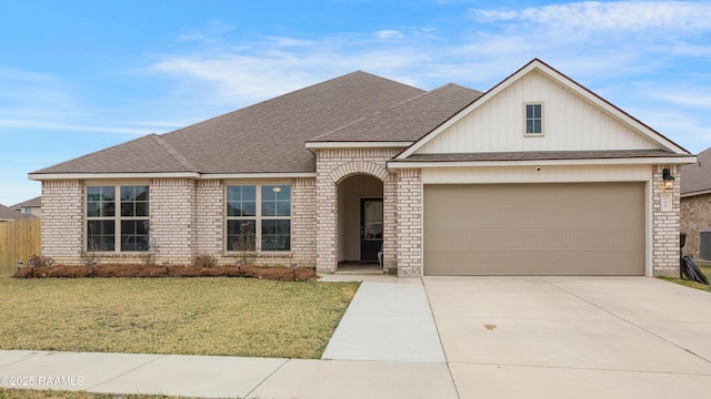 view of front of home with a garage and a front yard