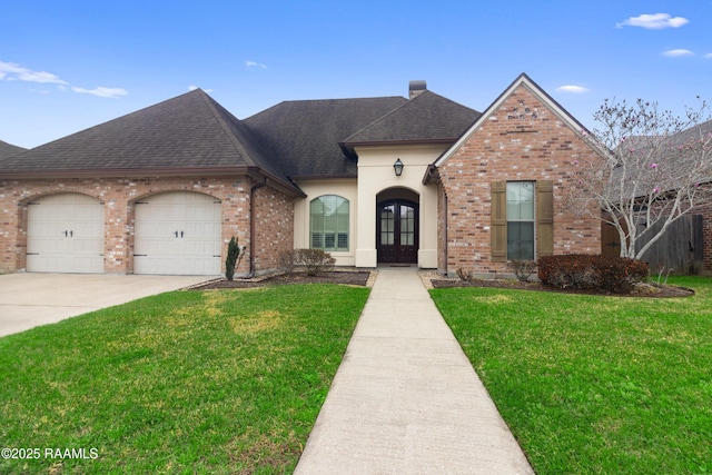 front facade with a front yard, french doors, and a garage