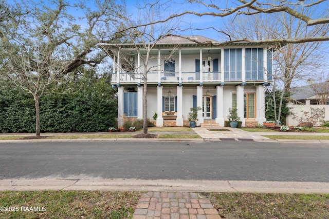 view of front of house featuring a balcony