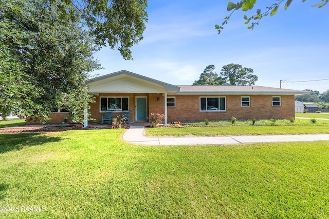 single story home with covered porch and a front lawn