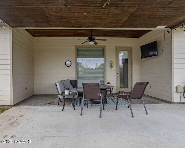 view of patio with outdoor dining area and a ceiling fan