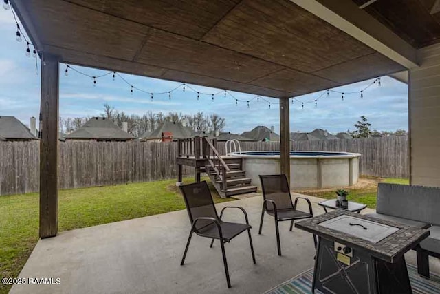 view of patio / terrace with outdoor lounge area, a fenced backyard, and a fenced in pool