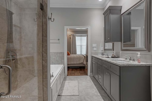 ensuite bathroom featuring a shower stall, crown molding, connected bathroom, and a sink