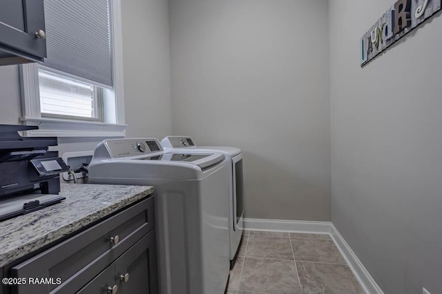 washroom with light tile patterned flooring, baseboards, and washer and clothes dryer