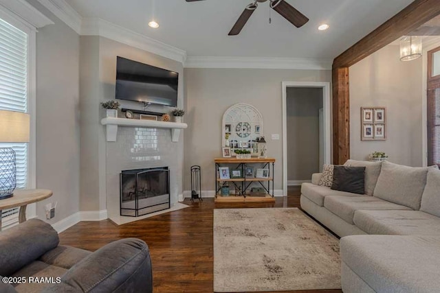 living area featuring dark wood finished floors, crown molding, a fireplace with flush hearth, and baseboards