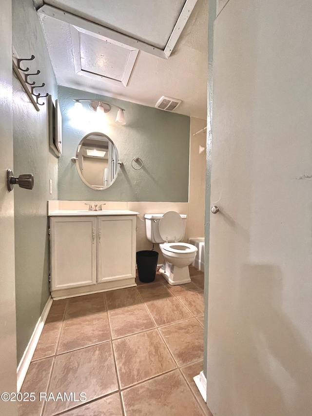 bathroom featuring tile patterned floors, toilet, and vanity