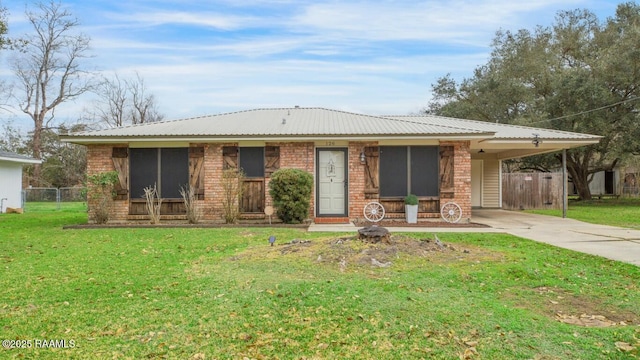 ranch-style house featuring a carport and a front lawn