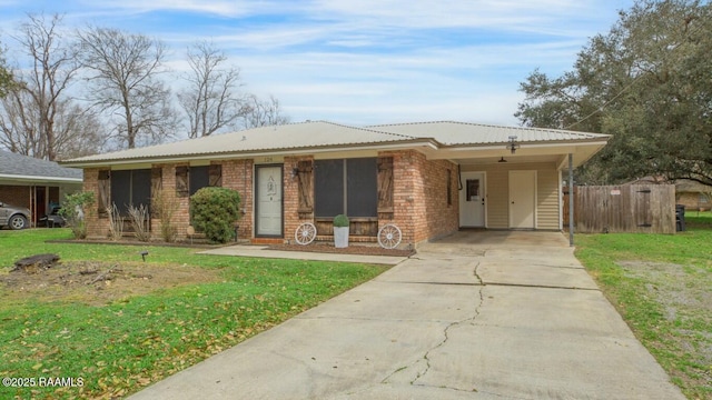 view of front facade with a carport and a front yard