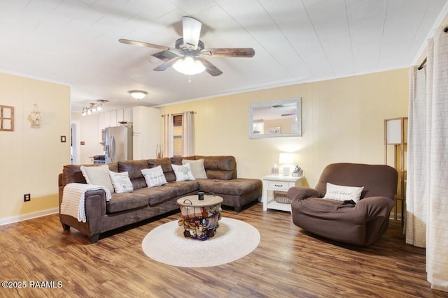 living room with hardwood / wood-style flooring, ceiling fan, and crown molding