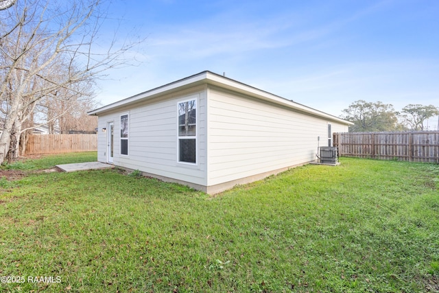 exterior space featuring a yard and central air condition unit