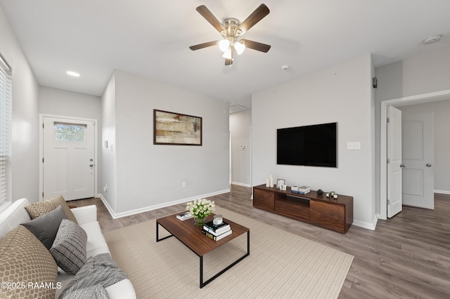 living room with hardwood / wood-style flooring and ceiling fan