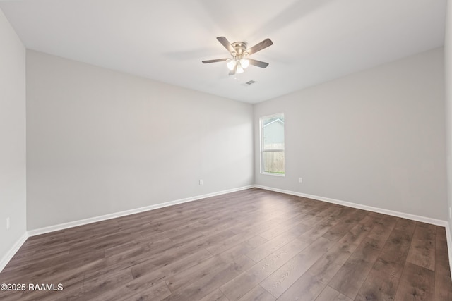 unfurnished room featuring ceiling fan and dark hardwood / wood-style flooring