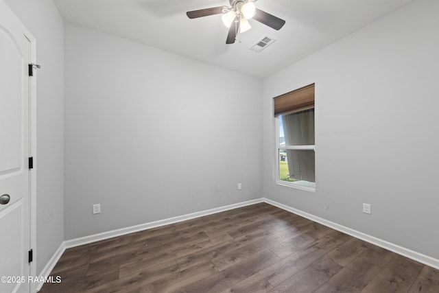 spare room featuring dark hardwood / wood-style floors and ceiling fan