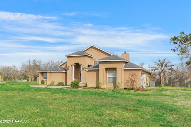 view of front of house with a front yard and central air condition unit