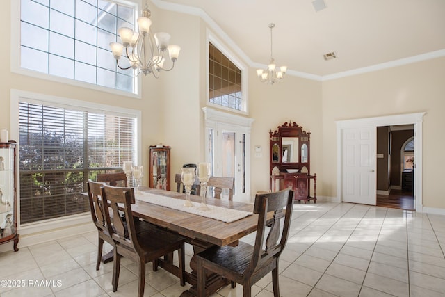 tiled dining area featuring crown molding, a chandelier, and a high ceiling