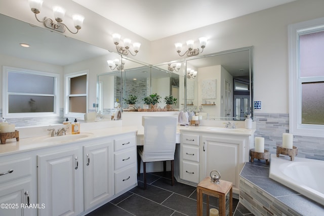 bathroom with vanity, tiled tub, and tile patterned flooring