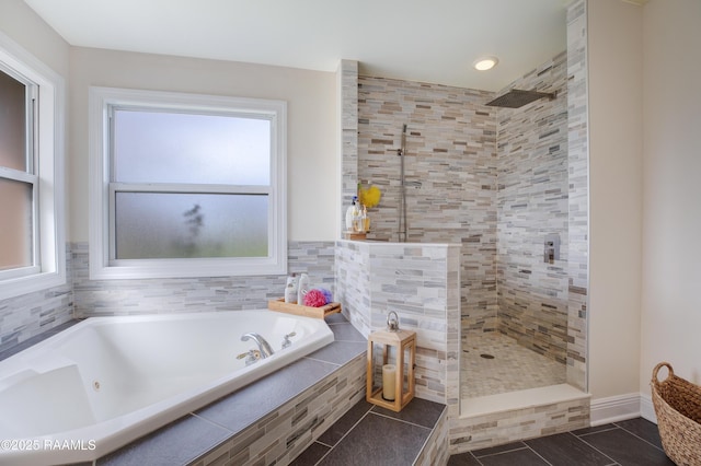 bathroom with tile patterned flooring and shower with separate bathtub