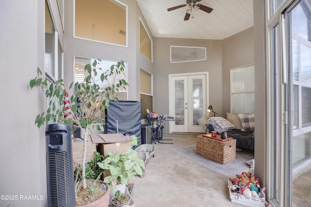 sunroom / solarium featuring a wealth of natural light, french doors, and ceiling fan