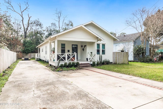 bungalow-style home featuring a porch and a front lawn