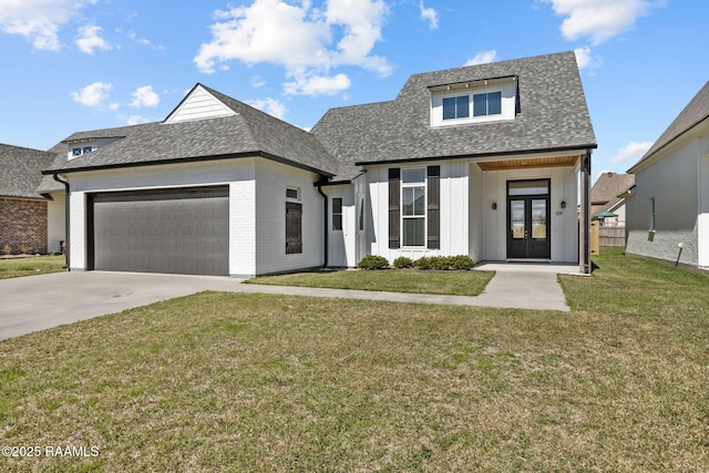 view of front of home featuring french doors, a front lawn, and a garage