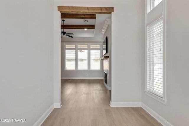 corridor with light wood-type flooring and beamed ceiling