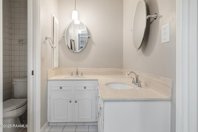 bathroom featuring vanity, tile patterned floors, and toilet