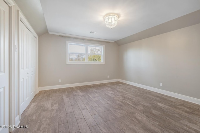 interior space featuring a closet, lofted ceiling, and light hardwood / wood-style flooring