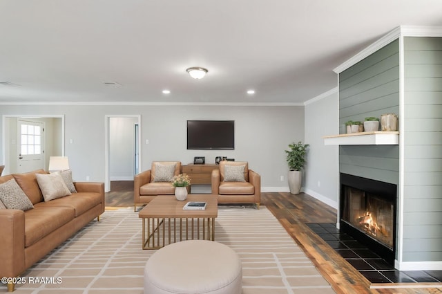 living room featuring ornamental molding, dark hardwood / wood-style floors, and a fireplace